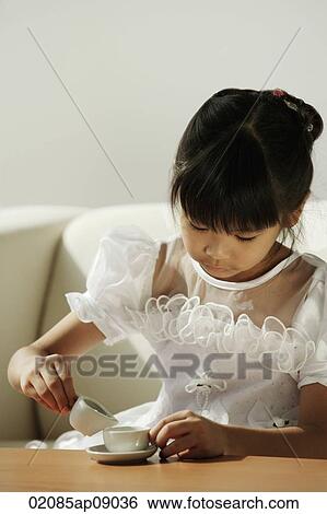 Girl in white dress playing with tea cups View Large Photo Image Stock Photograph - Girl in white dress playing with tea cups. Fotosearch