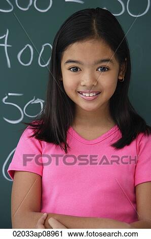 Girl standing in front of blackboard View Large Photo Image Stock Image - Girl standing in front of blackboard. Fotosearch