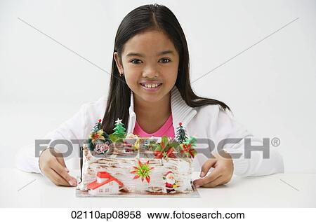 Girl with Christmas log cake smiling at camera View Large Photo Image Stock Photo - Girl with Christmas log cake smiling at camera. Fotosearch
