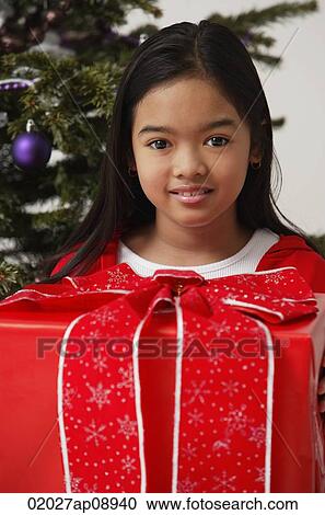 Stock Image - Girl with Christmas present. Fotosearch