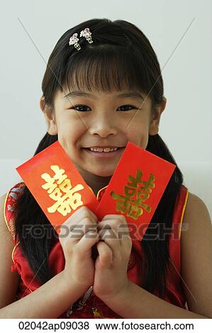 Girl with double happiness red packet, smiling at camera View Large Photo Image Stock Photo - Girl with double happiness red packet, smiling at camera. Fotosearch