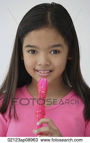 Girl with pink recorder, looking at camera View Large Photo Image Stock Image - Girl with pink recorder, looking at camera. Fotosearch
