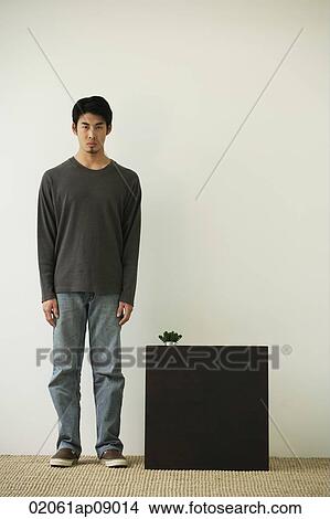 Picture - Young man looking at camera. Fotosearch