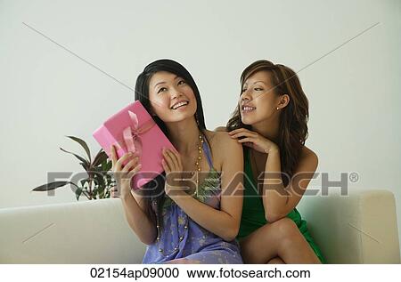 Young women with present View Large Photo Image Stock Image - Young women with present. Fotosearch
