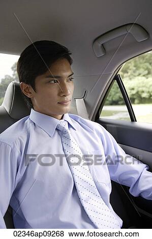 Businessman in backseat of car View Large Photo Image Stock Photo - Businessman in backseat of car. Fotosearch