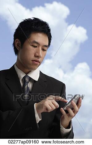 businessman using hand held device View Large Photo Image Stock Image - businessman using hand held device. Fotosearch