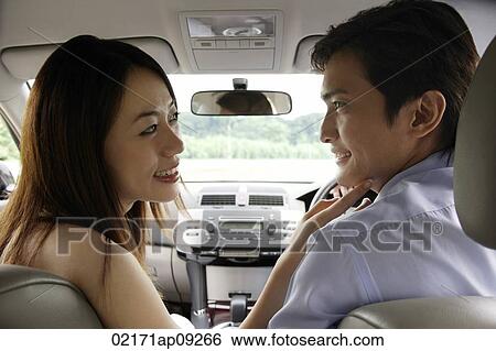 Stock Photograph - Couple driving in car. Fotosearch