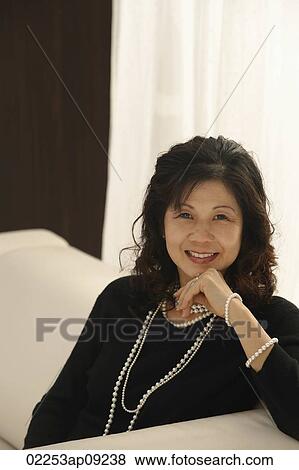 elegant woman sitting on couch View Large Photo Image Stock Photo - elegant woman sitting on couch. Fotosearch