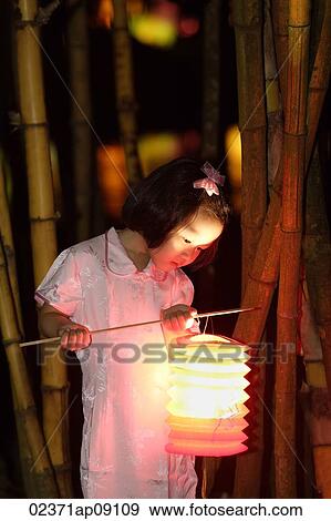 Little girl holding Chinese lantern View Large Photo Image Stock Photo - Little girl holding Chinese lantern. Fotosearch