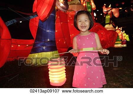 Little girl holding Chinese lantern View Large Photo Image Stock Photo - Little girl holding Chinese lantern. Fotosearch