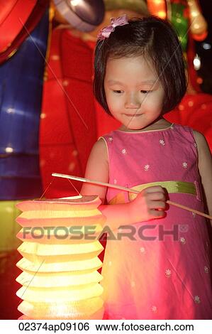 Little girl holding Chinese lantern View Large Photo Image Stock Photograph - Little girl holding Chinese lantern. Fotosearch