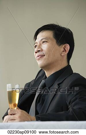 Man enjoying glass of champagne View Large Photo Image Stock Image - Man enjoying glass of champagne. Fotosearch