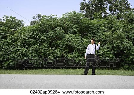 Man hitch hiking View Large Photo Image Picture - Man hitch hiking. Fotosearch