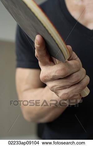 Man holding ping pong paddle View Large Photo Image Picture - Man holding ping pong paddle. Fotosearch