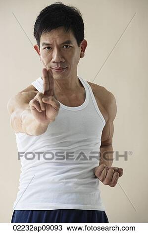 Stock Image - Man in martial arts pose. Fotosearch