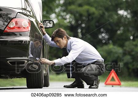 Stock Photography - Man inspecting car. Fotosearch