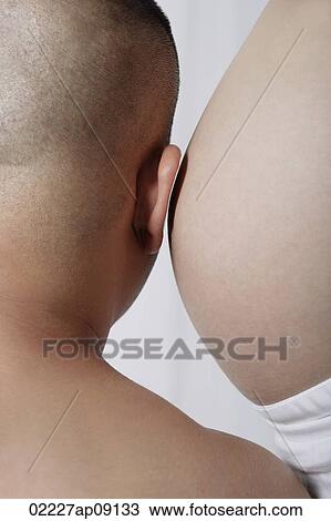 Man leaning ear against pregnant stomach View Large Photo Image Stock Image - Man leaning ear against pregnant stomach. Fotosearch