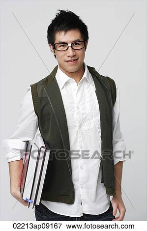 Nerdy man with books View Large Photo Image Stock Photo - Nerdy man with books. Fotosearch