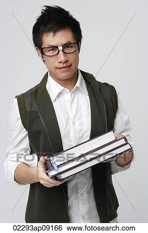Nerdy man with books View Large Photo Image Stock Photograph - Nerdy man with books. Fotosearch