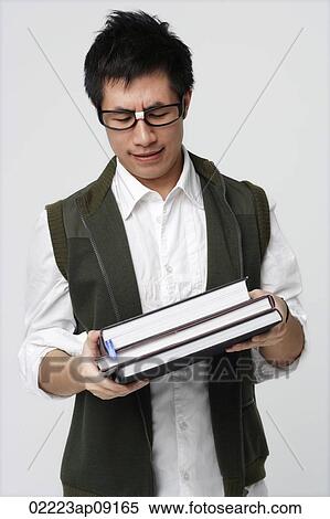 Nerdy man with books View Large Photo Image Stock Photography - Nerdy man with books. Fotosearch