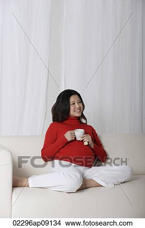 Pregnant woman enjoying tea View Large Photo Image Picture - Pregnant woman enjoying tea. Fotosearch
