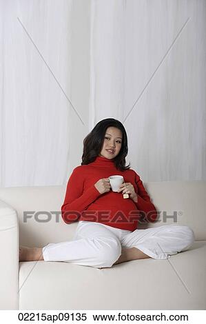 Stock Photography - Pregnant woman enjoying tea. Fotosearch
