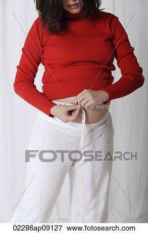 Pregnant woman measuring stomach View Large Photo Image Stock Photo - Pregnant woman measuring stomach. Fotosearch