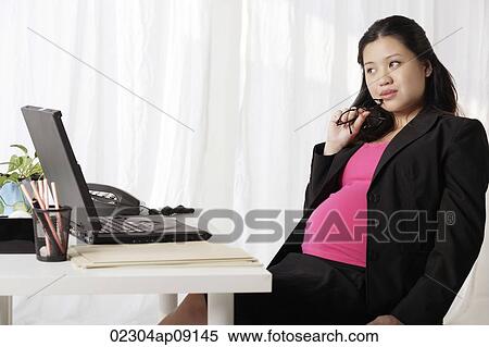 Profile of pregnant businesswoman at desk View Large Photo Image Stock Photography - Profile of pregnant businesswoman at desk. Fotosearch