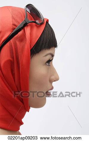 Profile of woman wearing red scarf and sunglasses View Large Photo Image Stock Image - Profile of woman wearing red scarf and sunglasses. Fotosearch