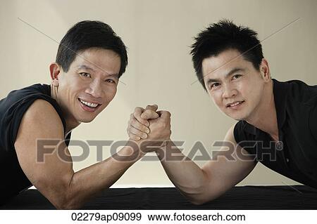 Stock Photo - Two men ready to arm wrestle. Fotosearch