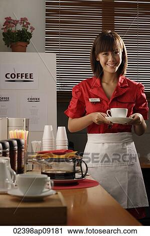 Waitress in diner holding coffee View Large Photo Image Stock Image - Waitress in diner holding coffee. Fotosearch