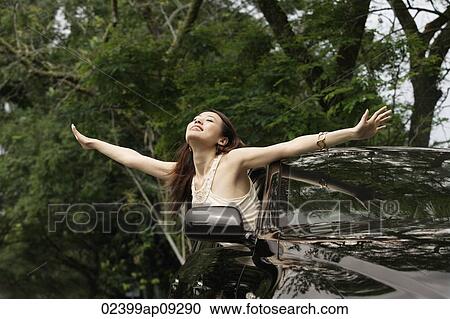 Woman hanging out car window View Large Photo Image Stock Image - Woman hanging out car window. Fotosearch