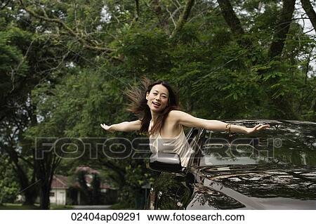 Woman hanging out car window View Large Photo Image Stock Image - Woman hanging out car window. Fotosearch
