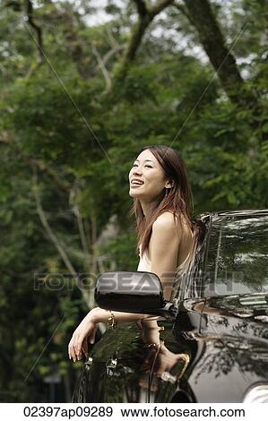 Woman hanging out car window View Large Photo Image Stock Photo - Woman hanging out car window. Fotosearch