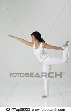 Stock Image - Woman practicing yoga. Fotosearch