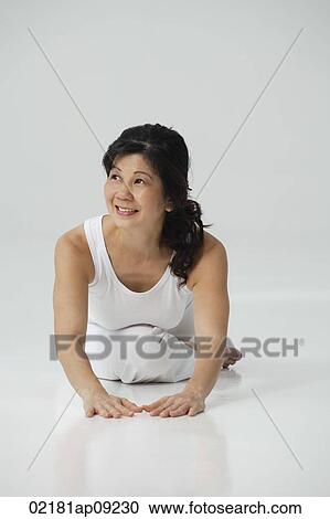 Woman practicing yoga View Large Photo Image Stock Image - Woman practicing yoga. Fotosearch