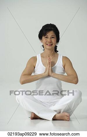 Woman sitting in yoga posture View Large Photo Image Stock Photo - Woman sitting in yoga posture. Fotosearch