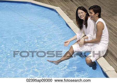 Young couple having fun by pool View Large Photo Image Stock Image - Young couple having fun by pool. Fotosearch