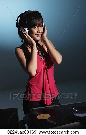 Stock Photo - Young woman DJ. Fotosearch