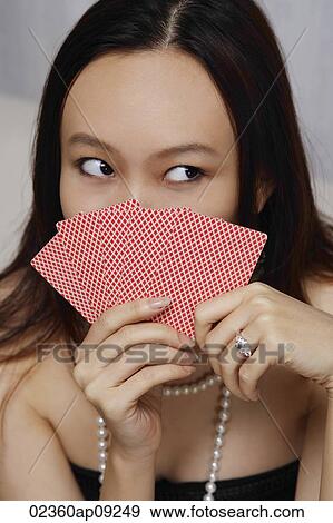 Young woman holding game cards View Large Photo Image Stock Photo - Young woman holding game cards. Fotosearch