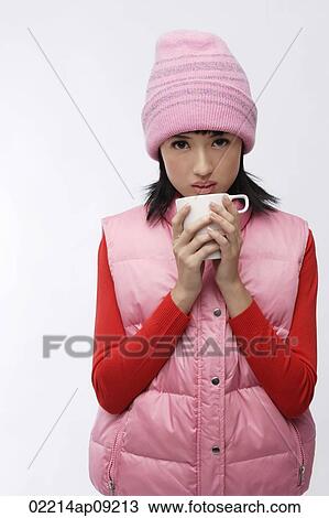 Young woman in pink hat and vest with coffee cup View Large Photo Image Stock Image - Young woman in pink hat and vest with coffee cup. Fotosearch
