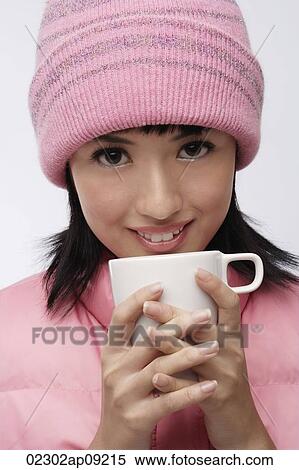 Young woman in pink hat and vest with coffee cup View Large Photo Image Stock Photography - Young woman in pink hat and vest with coffee cup. Fotosearch