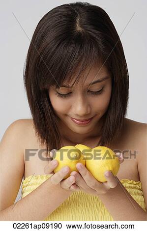 Young woman smelling lemons View Large Photo Image Stock Image - Young woman smelling lemons. Fotosearch