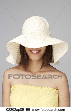 Young woman with big sun hat View Large Photo Image Stock Photography - Young woman with big sun hat. Fotosearch