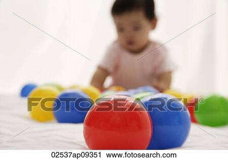 baby girl playing with balls View Large Photo Image Stock Image - baby girl playing with balls. Fotosearch