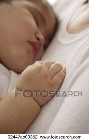 baby girl sleeping against woman's chest View Large Photo Image Stock Image - baby girl sleeping against woman's chest. Fotosearch
