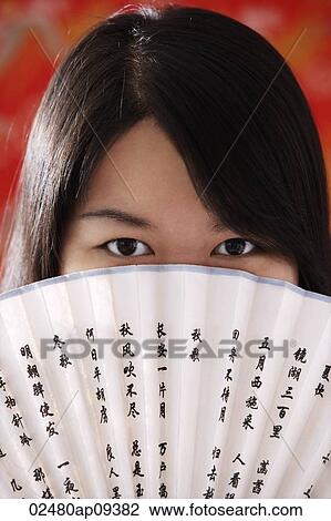 Chinese woman looking over hand-held fan with Chinese characters View Large Photo Image Stock Image - Chinese woman looking over hand-held fan with Chinese characters. Fotosearch