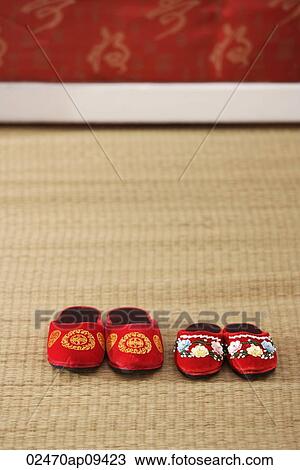 Still life of 2 pairs of red shoes on weaved mat View Large Photo Image Stock Image - Still life of 2 pairs of red shoes on weaved mat. Fotosearch