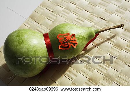 Still life of bottle gourd on weaved mat View Large Photo Image Stock Photograph - Still life of bottle gourd on weaved mat. Fotosearch