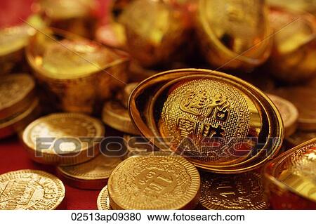 Stock Image - Still life of gold coins and ingots. Fotosearch
